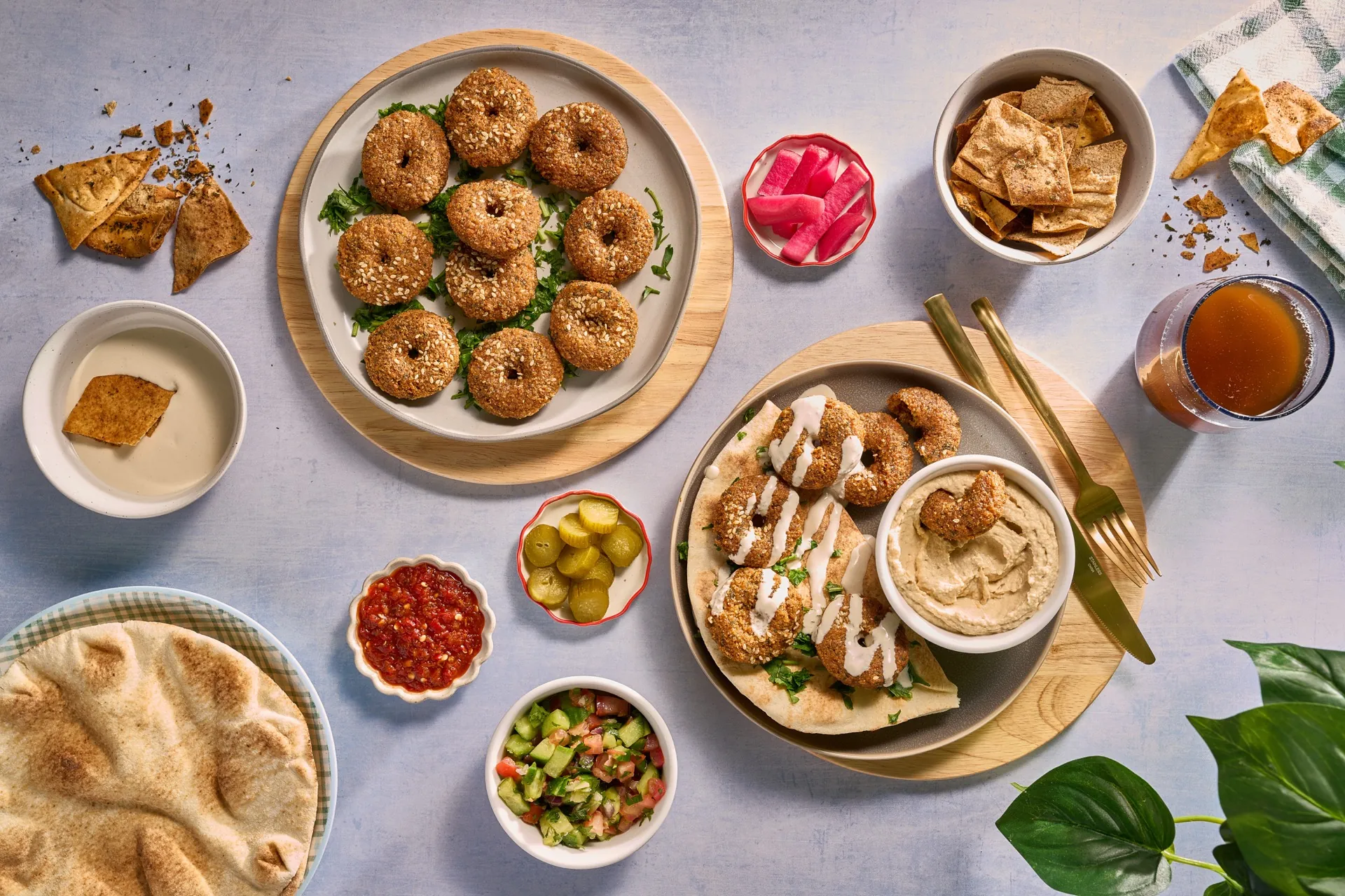Fresh falafel platter with Mediterranean dips, pickled vegetables, and warm pita bread