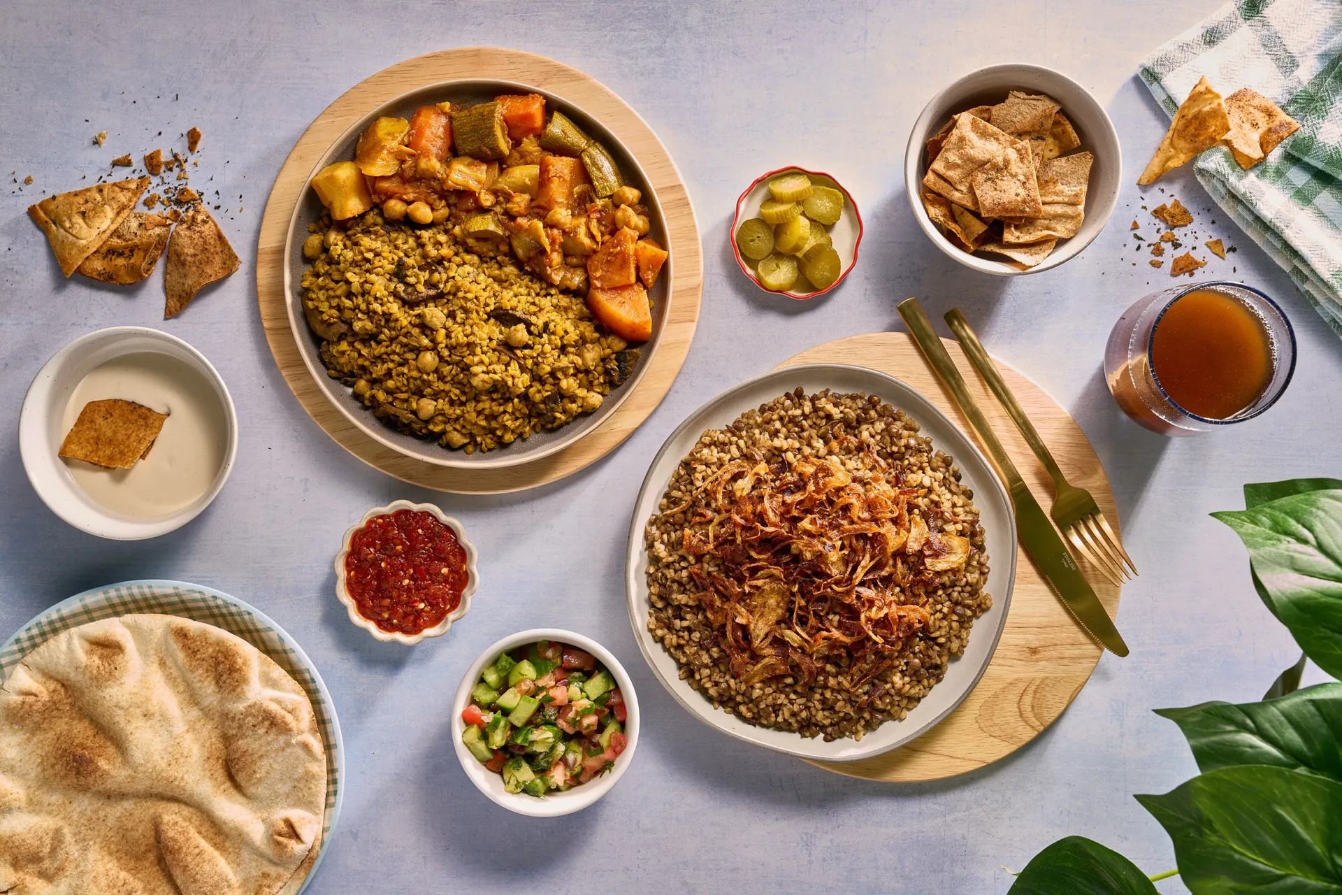A full Mediterranean spread with grain bowls, fresh salad, pita, and traditional sides